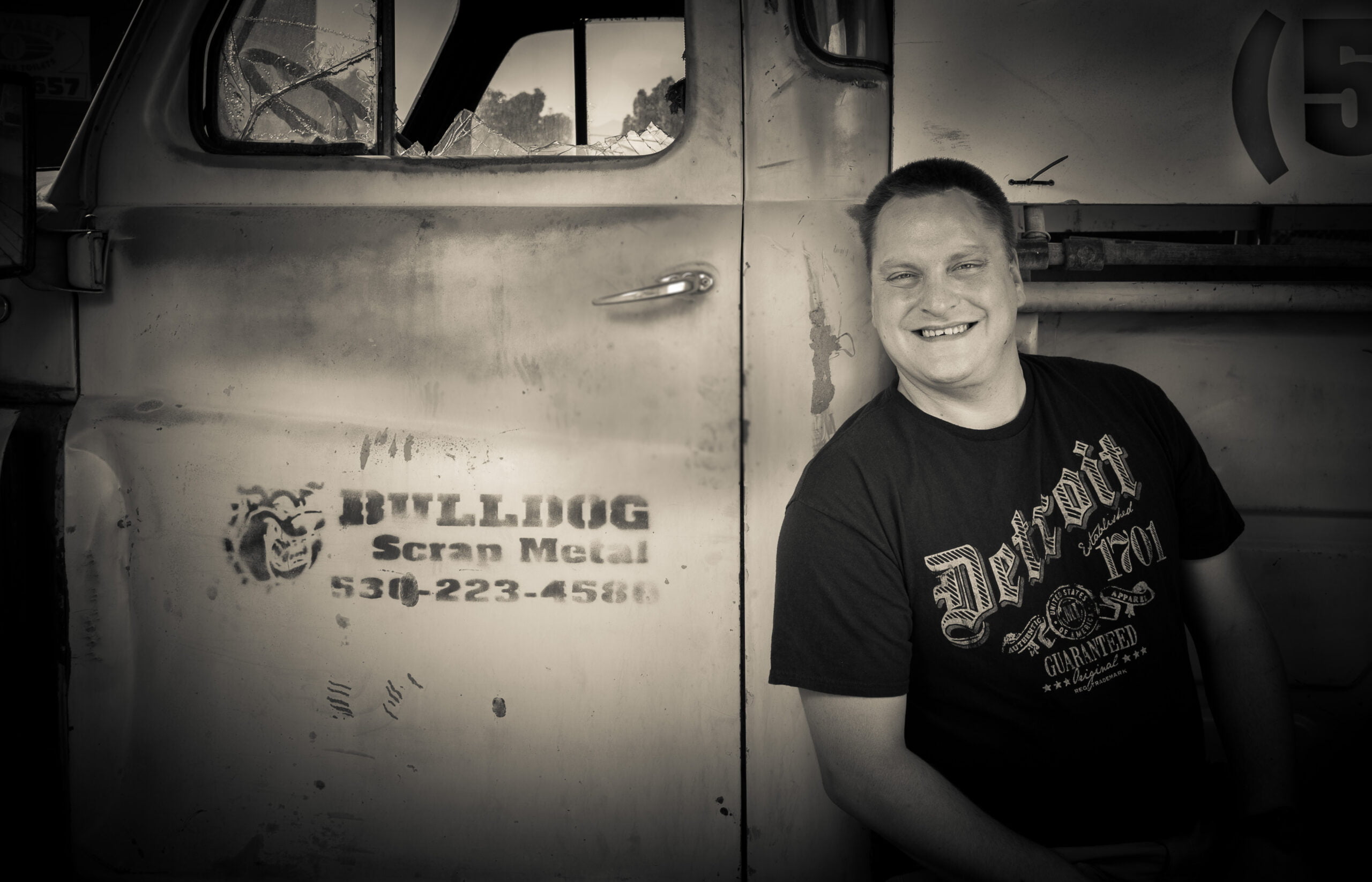 Matthew Sprenger in front of Bulldog Scrap Metal truck.