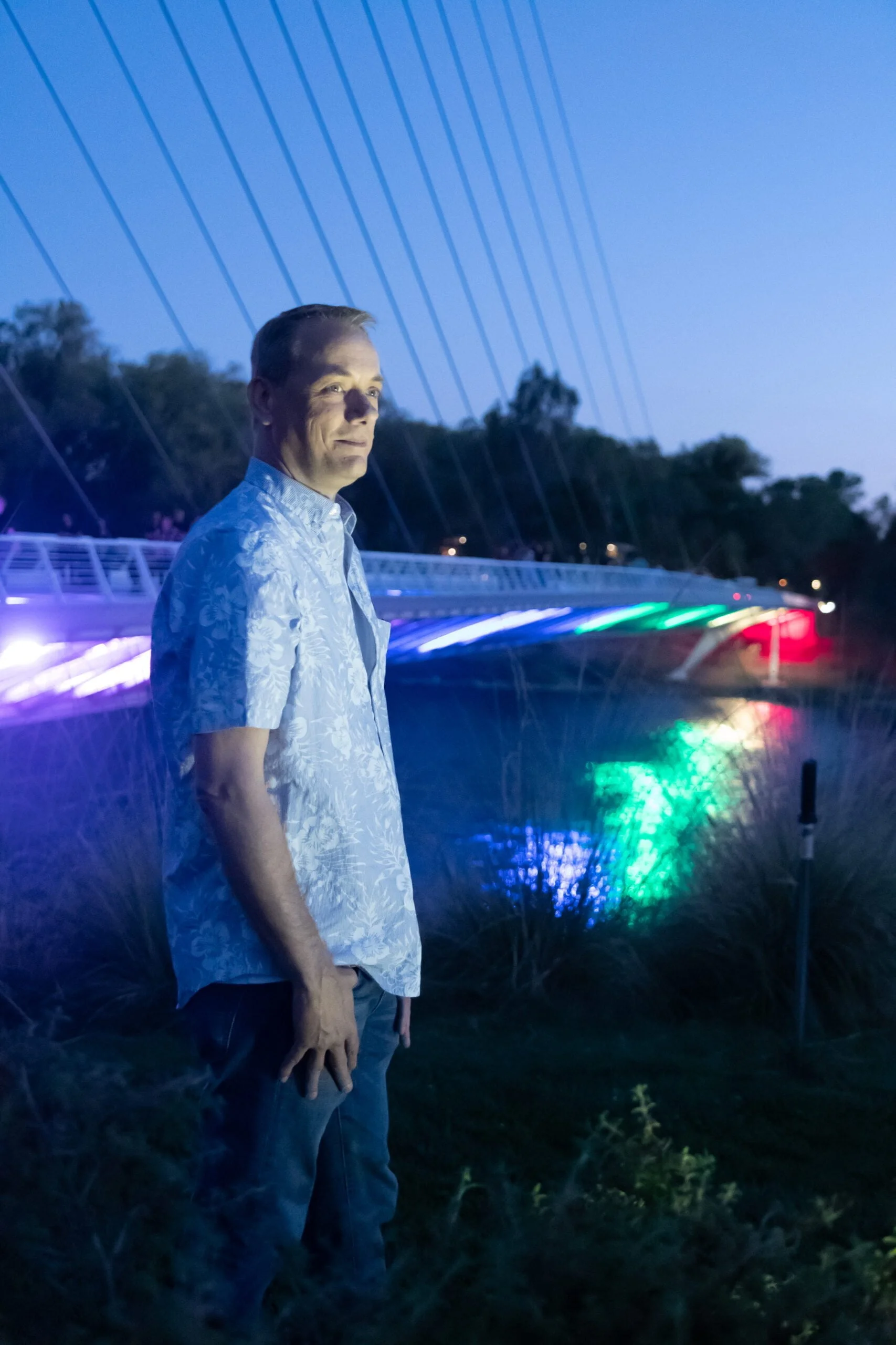 David Wharton by the Sundial Bridge lit in rainbow colors for Pride