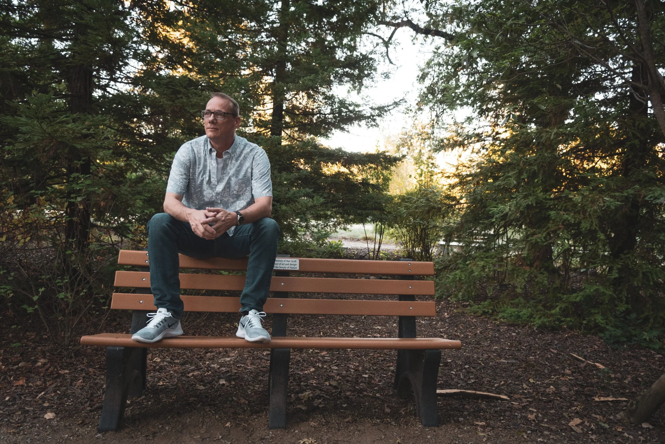 David Wharton on a bench at the McConnell Gardens