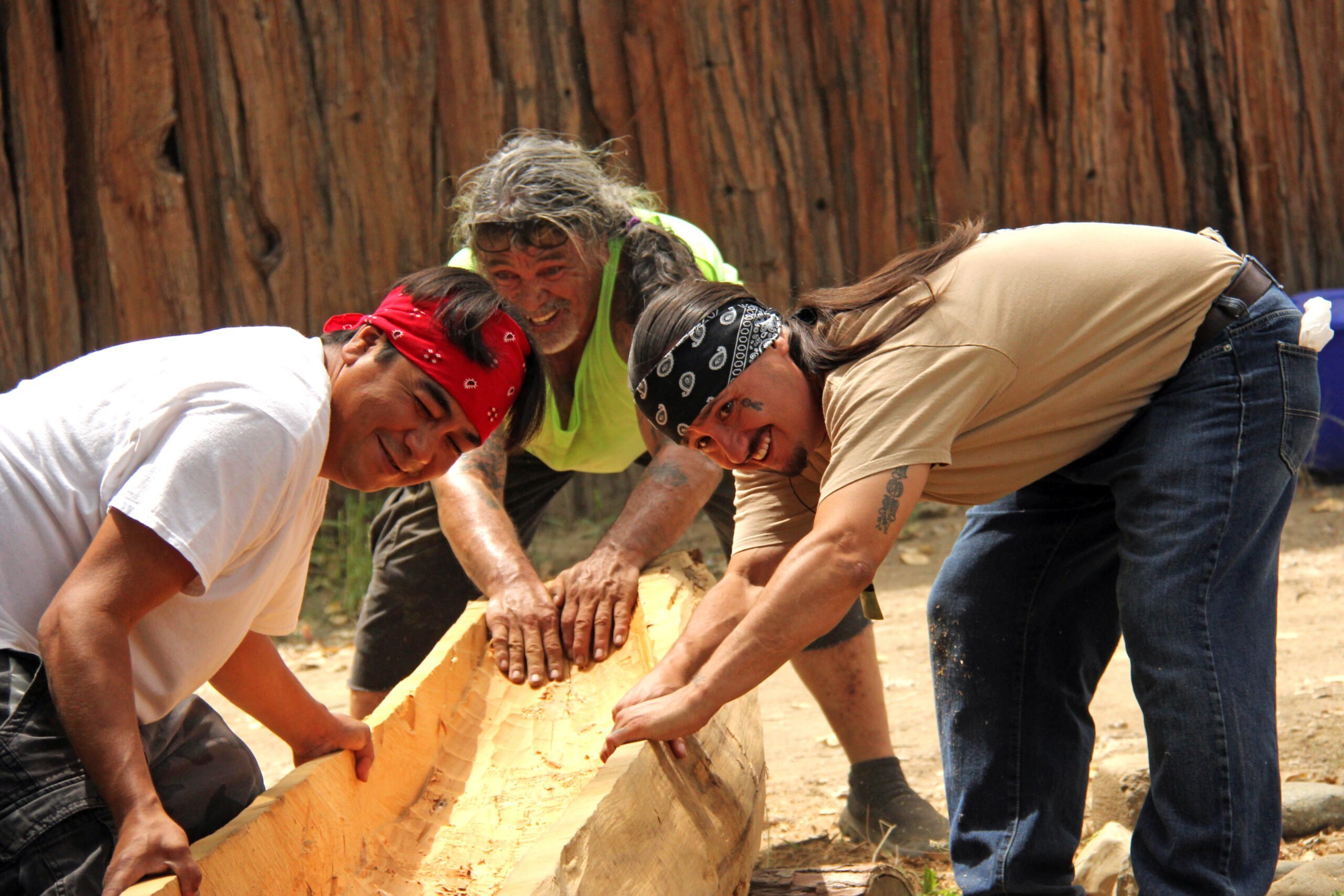 Junior helps build a traditional dugout canoe.