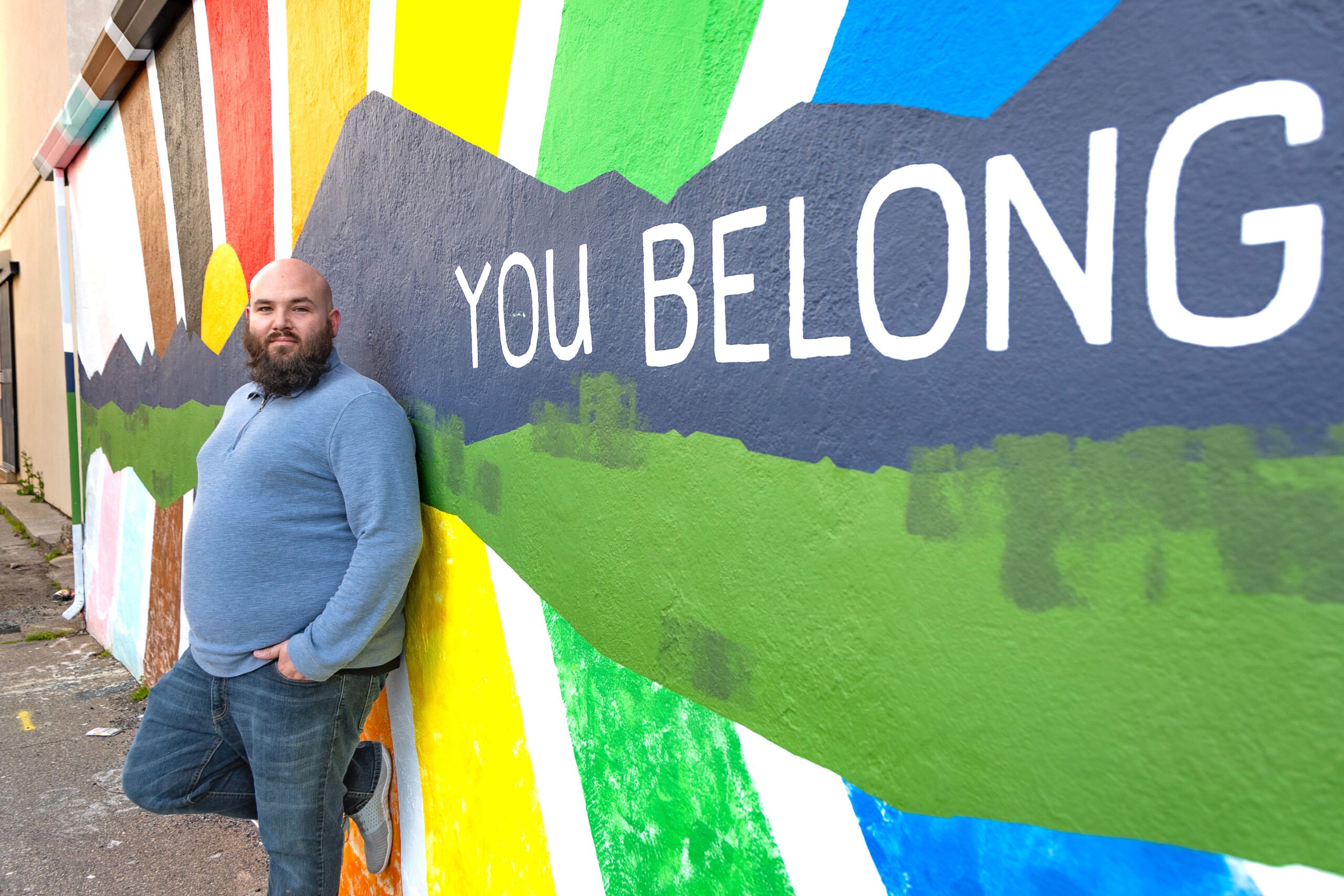 Keith Jackson standing in front of the iconic You Belong mural in downtown Redding.